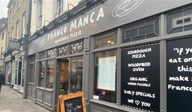 Outside Franco Manca in Greenwich, showing a classy restaurant with lots to offer.