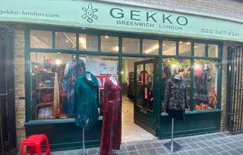Outside GEKKO in Greenwich, showing a green shop front with a range of clothing on show.