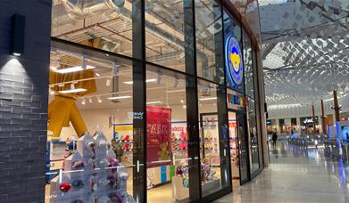Outside Build-A-Bear at The O2. Showing a large building with windows revealing a range of toys.