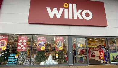 Outside Wilko in Charlton. A large shop with glass doors and a red sign outside.