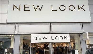 Outside New Look in Charlton, showing a large white building with a huge selection of fashionable items.