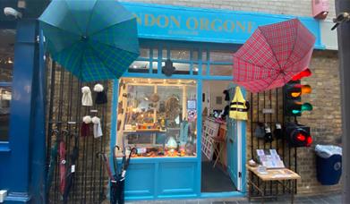 Outside London Orgone. A stunning shop, with a light blue and gold design. Also having a unique umbrella display outside.