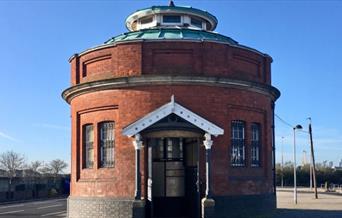 A guard house looking, red brick Woolwich Foot Tunnel entrance.