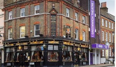 Exterior image of Ye Olde Rose and Crown pub with black window frames. The pub has Greenwich Theatre right next to it.
