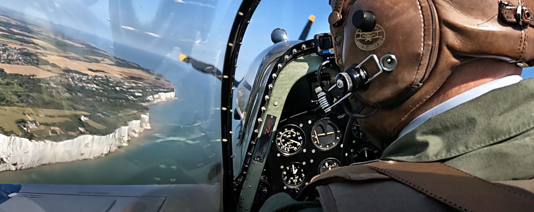 A Spitfire flying over the White Cliffs at Dover