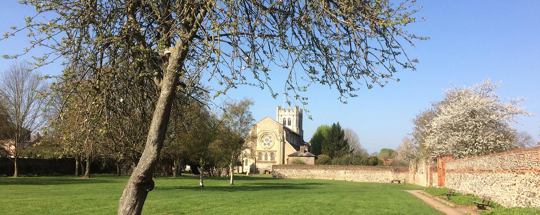 view across the garden to the exterior of Waltham Abbey church