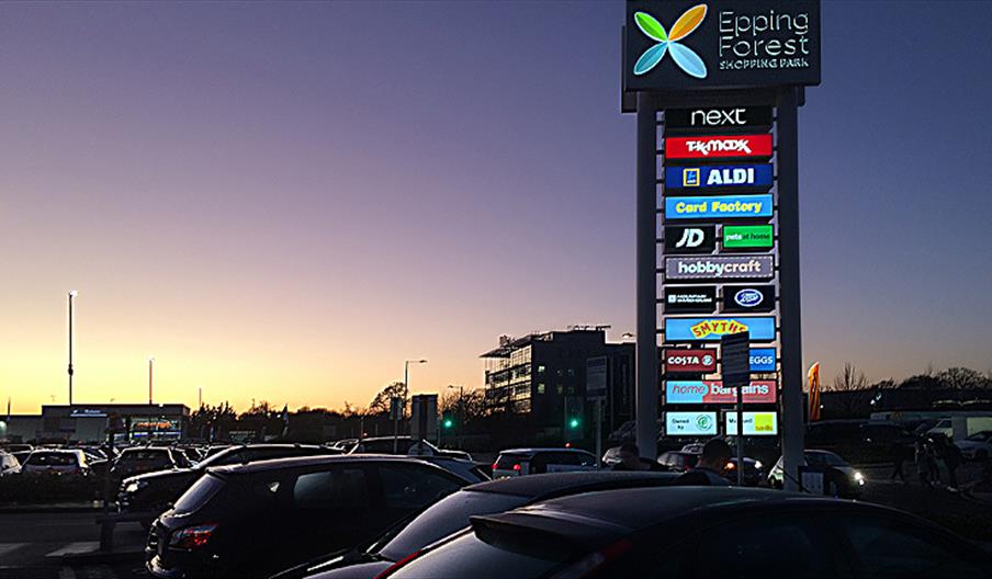 Epping Forest Shopping Park at dusk.