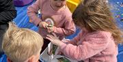 Kids having school holiday fun at Play in the Park provided free at locations across the district by Epping Forest District Council