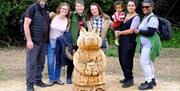 Visitors and a Brambly Hedge character sculpture along the Epping Forest Brambly Hedge Trail.