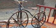 John Collins Collection, Hedges Bone Shaker 1867. This type of cycle was invented in 1861 by adding cranked pedals to a Hobby Horse.