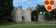 The city gates into the medieval walled town of Boulogne and the arms of Boulogne.