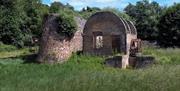A water-wheel powered hydraulic press house and press with protective wall in between at the Royal Gunpowder Mills