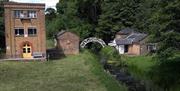 Canal, wildlife centre, bridge and magazine building with veranda to unload barges  at the Royal Gunpowder Mills