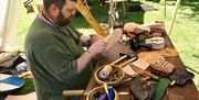 Demonstration of leatherwork at an International Living History Festival