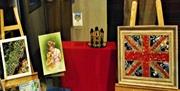 Various works of art displayed in a shop window as part of Waltham Abbey Art Trail