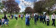 The procession travelling through the Abbey Grounds in Waltham Abbey