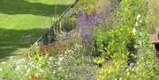 Border flower beds alongside the wall at Copped Hall