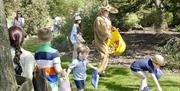 Children hunting Easter eggs at Copped Hallz.