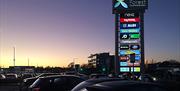 Epping Forest Shopping Park at dusk.