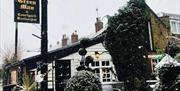 The Green Man & Courtyard on a snowy day