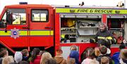 School children learning about the role of the firemen and their fire and rescue equipment on North Weald Airfield