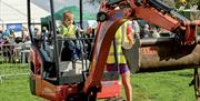 Kids get to try out a digger at the IWA Festival of Water