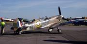 A Spitfire is readied for flight on the apron at North Weald Airfield.