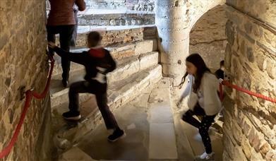 Children climbing the spiral staircase in the Castle