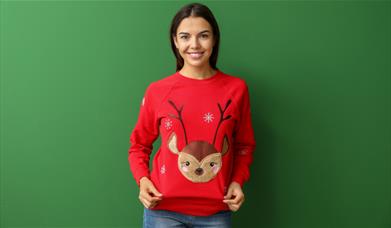 Woman wearing Christmas jumper with reindeer on