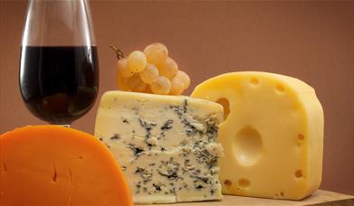 Selection of cheeses with a glass of red wine