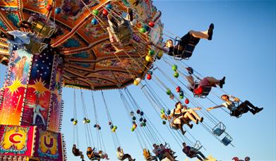 People riding on a fairground ride.