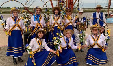 Alive and Kicking Morris Dancing side in blue and yellow costumes