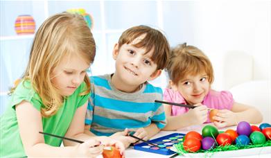 Children decorating Easter eggs
