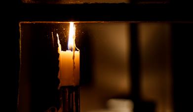 Candle burning on a windowsill