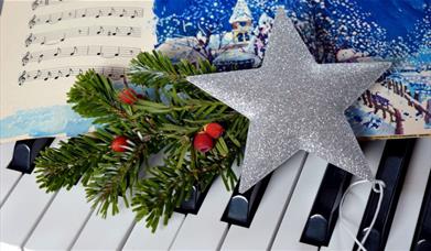 Christmas star on piano keyboard