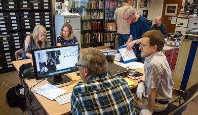 Volunteers scanning and digitising photos of jazz musicians