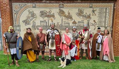 Roman re-enactors in front of a modern day mosaic
