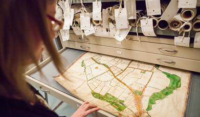 Person viewing the Walker Map of Chelmsford at the Essex Record Office