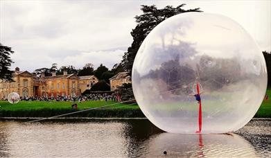 A large inflatable sphere on a lake