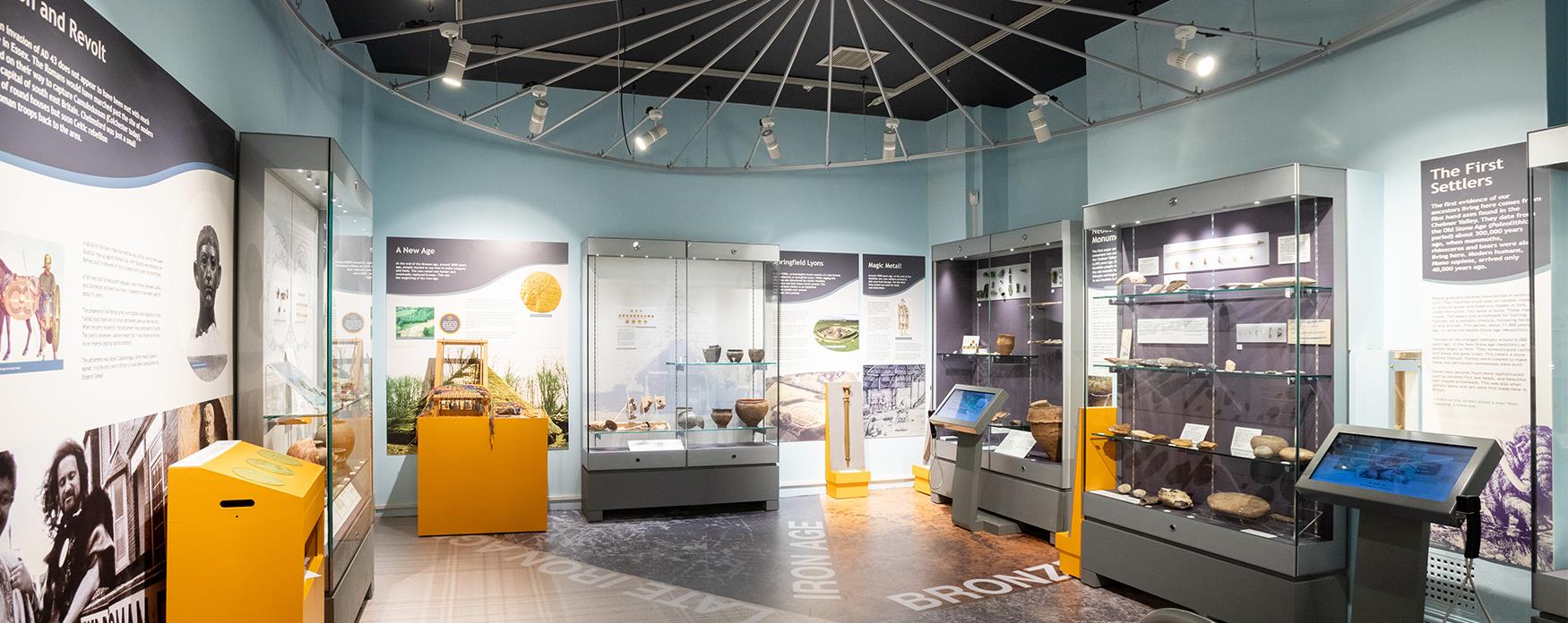 Chelmsford Museum interior with display cabinets, wall panels and interactive screens