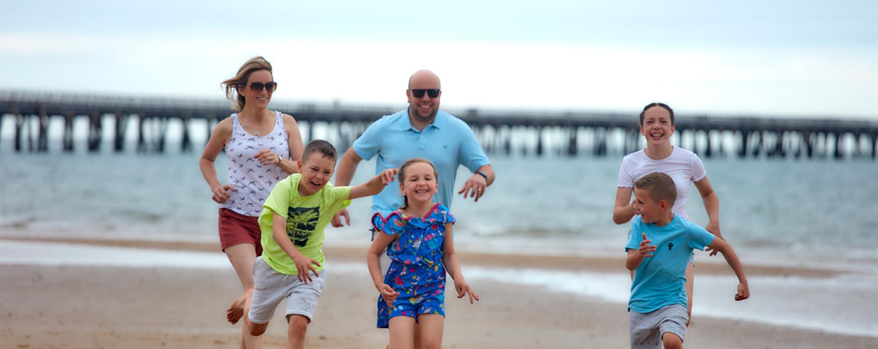 Family running on beach