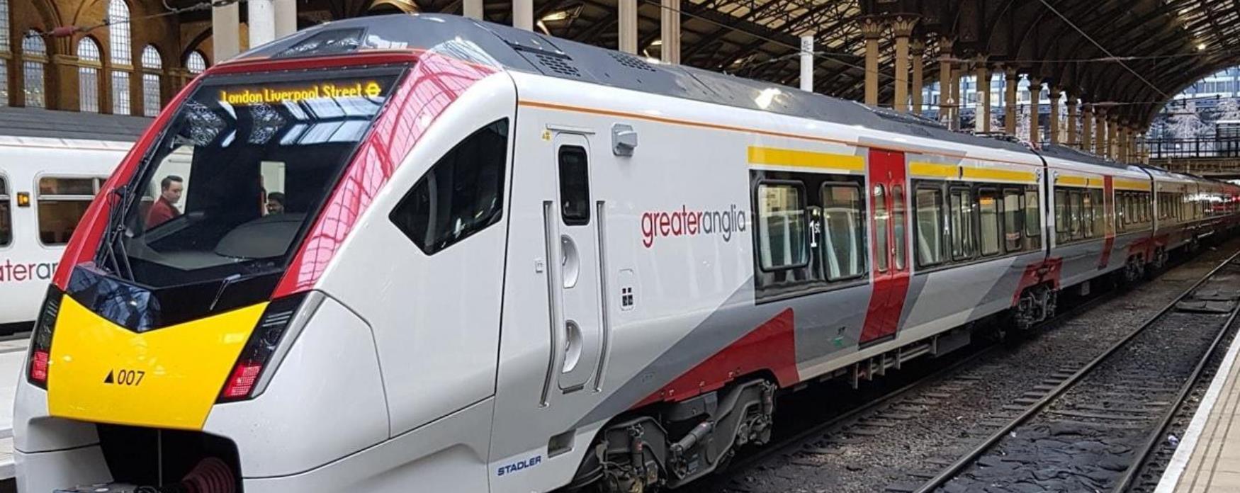 A Greater Anglia train stopped at a platform.