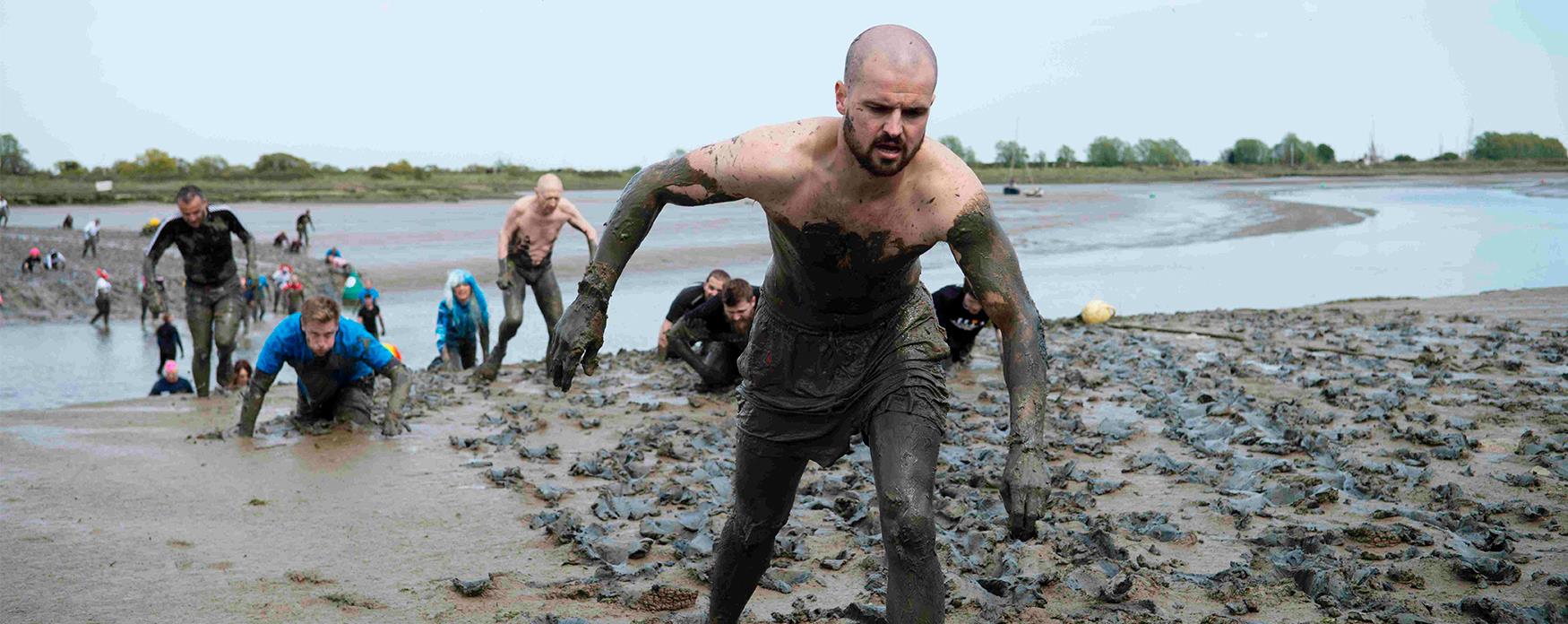 Participants wading through the mud