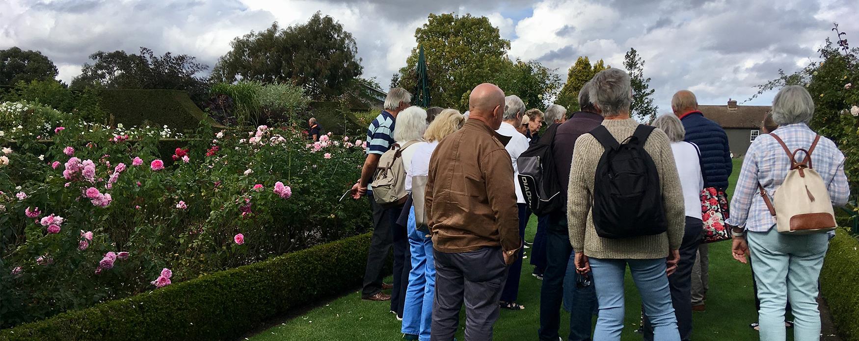 A group admiring the gardens at RHS Hyde Hall