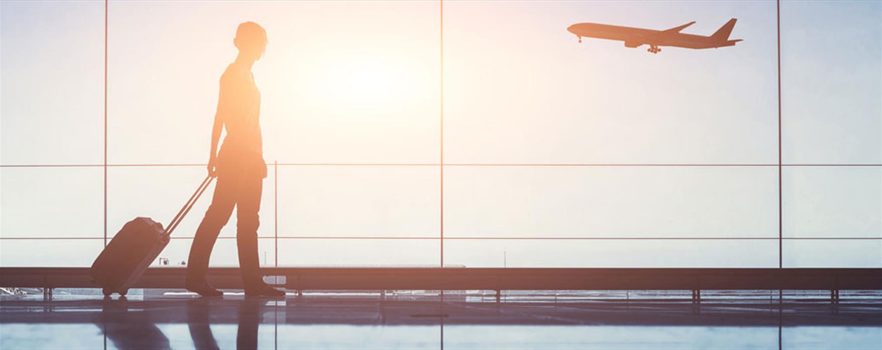 Airport terminal people traveling, silhouette of woman passenger with baggage in airport