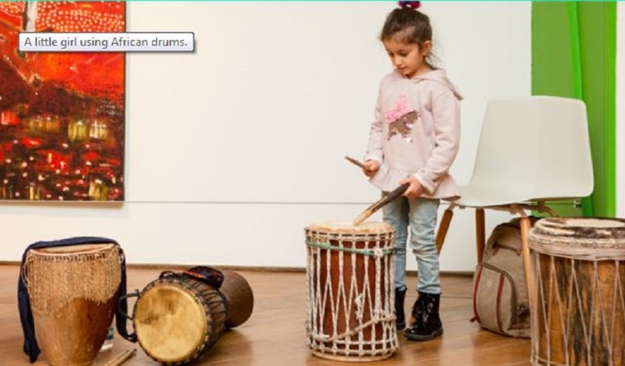 A young girl playing he drums