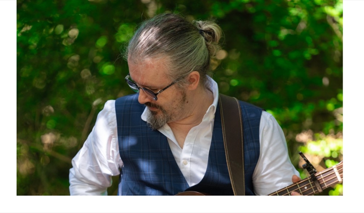 Dan Fraser playing the guitar