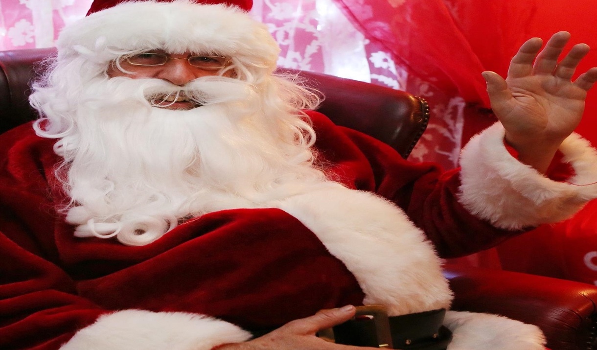 Father Christmas is smiling and waving