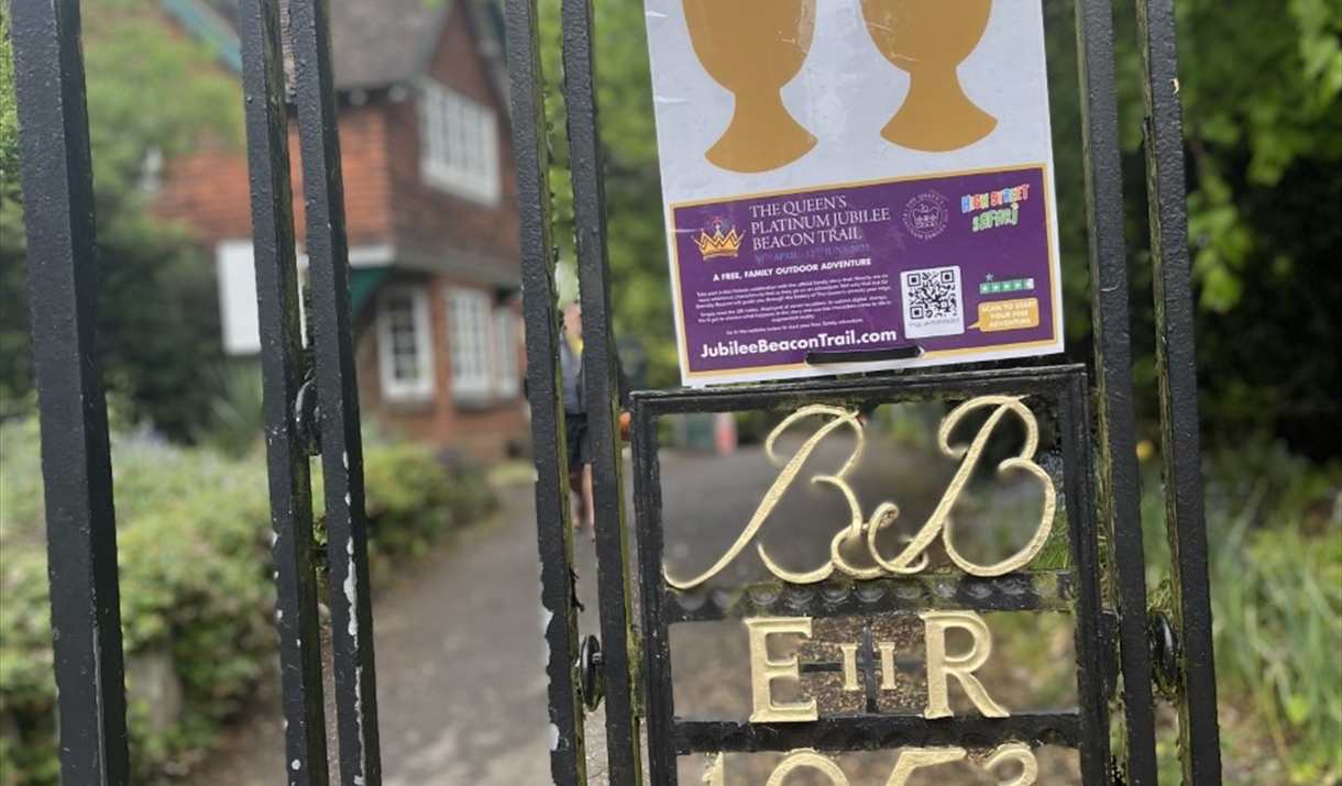 Park gates with Queen's crest and sign for High Street Safari Beacon trail