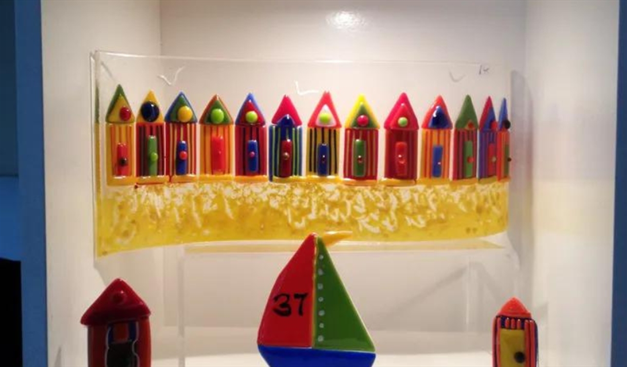 Fused glass in the shape of beach huts and boats by Ania Originals